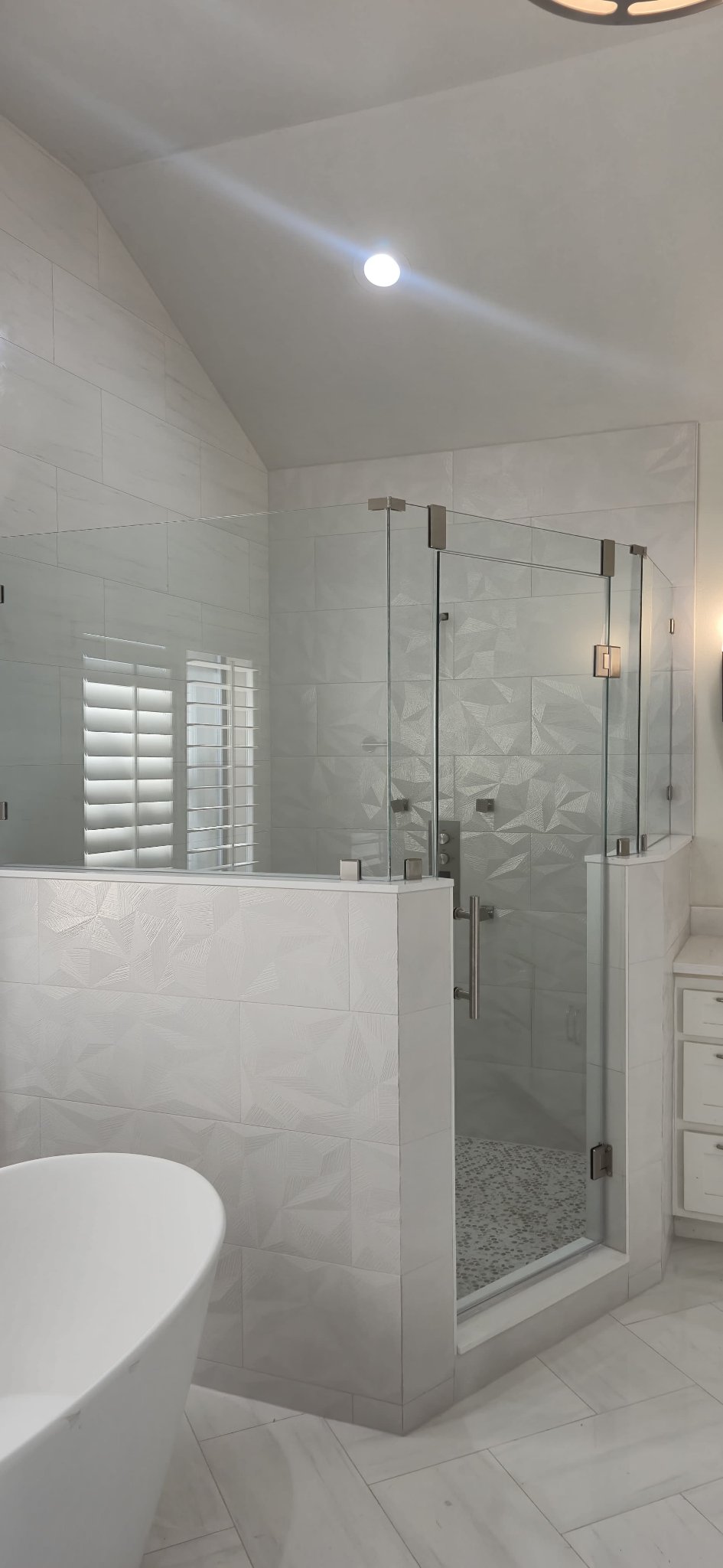 135° angle over half walls bathroom reference photo: the glass panels are mounted on tile half walls, with the door in the center and brushed nickel hardware