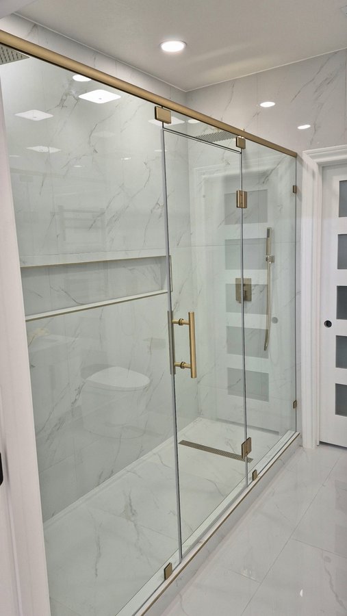 Glas Plus hinged door with side panels WITH top bar example: a brush gold bar joins the panels at the top