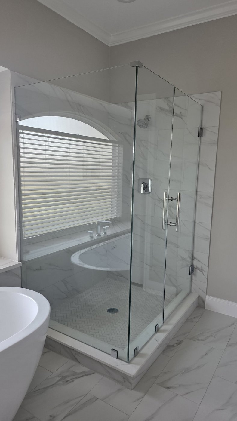 Glas Plus job: 90° angle with chrome hardware in a marble bathroom