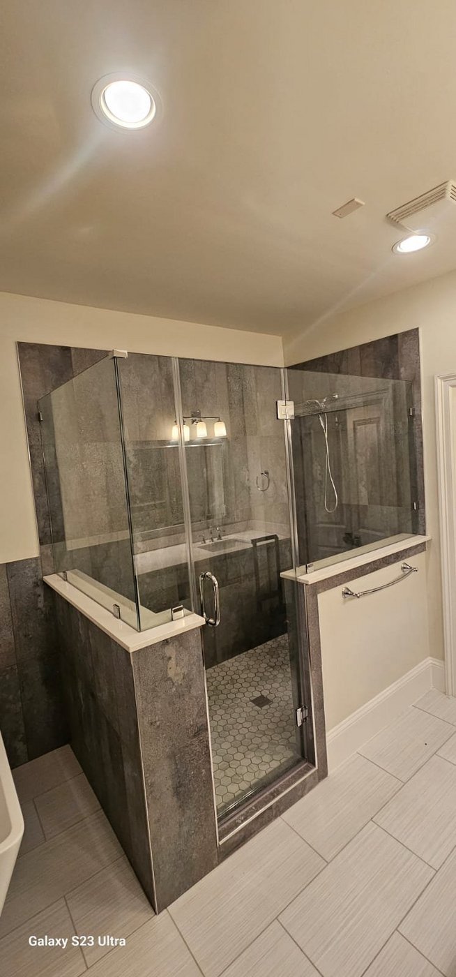 Glas Plus job: glass panels over walls with a center door