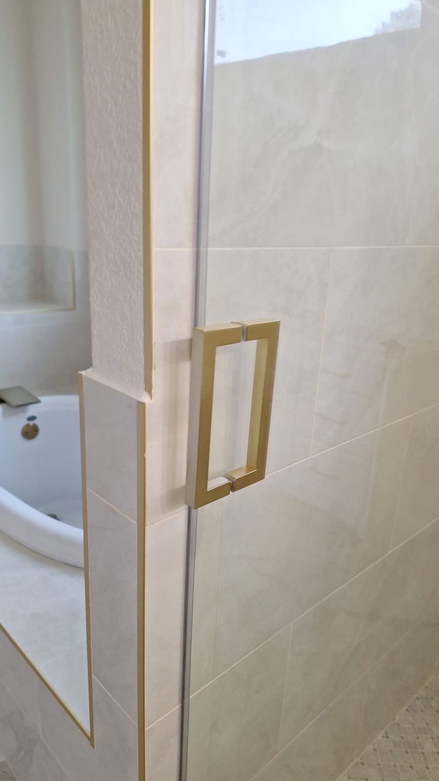 Glas Plus square brush gold handle installed on a glass shower door