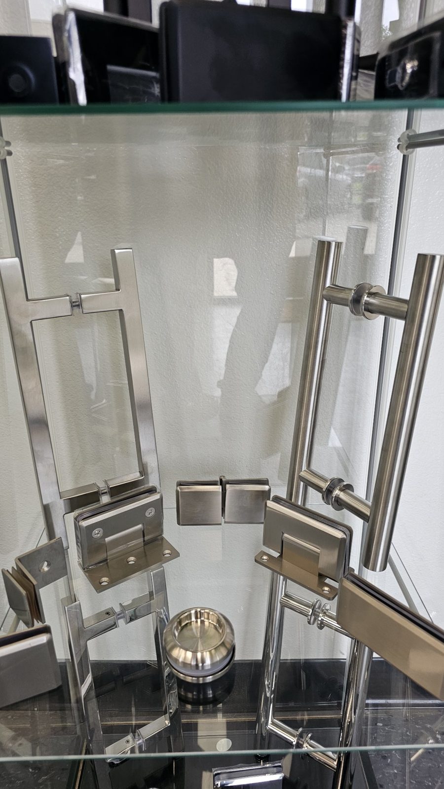 Glas Plus brush nickel hardware set in a display case: handles, hinges and clips in brushed nickel