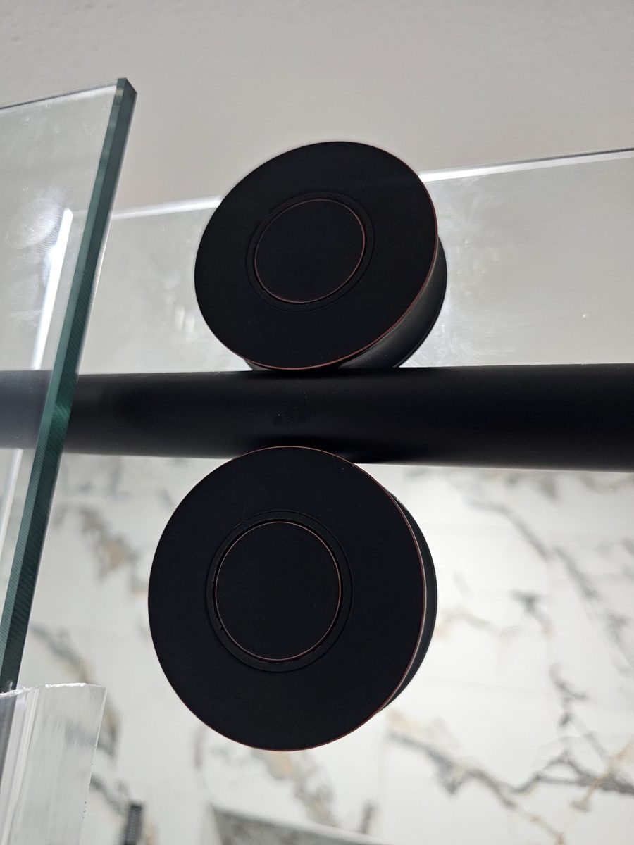 Glas Plus black sliding rollers or wheels mounted on a black track