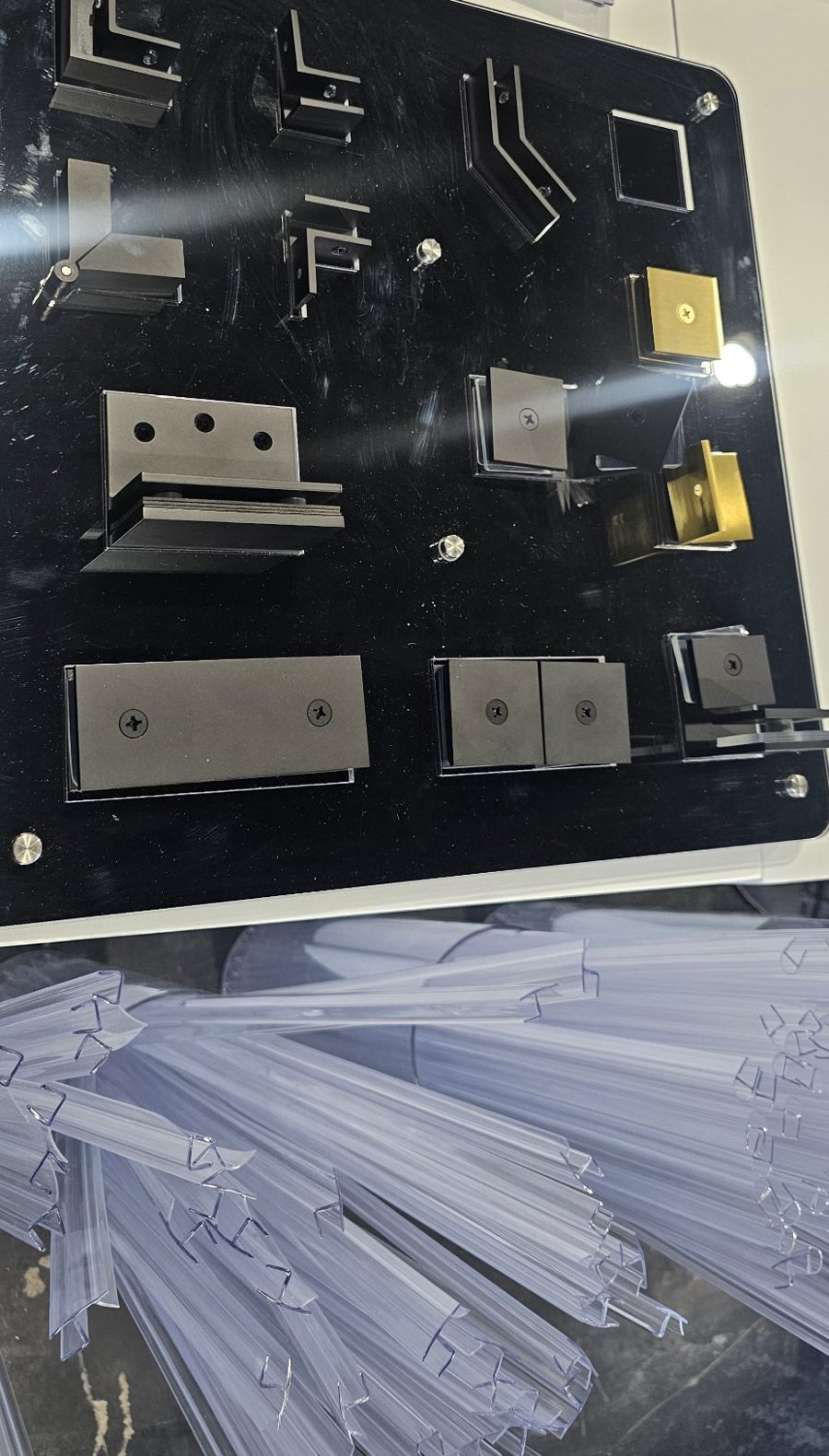 Glas Plus board of clips and clamps in dark and gold tones