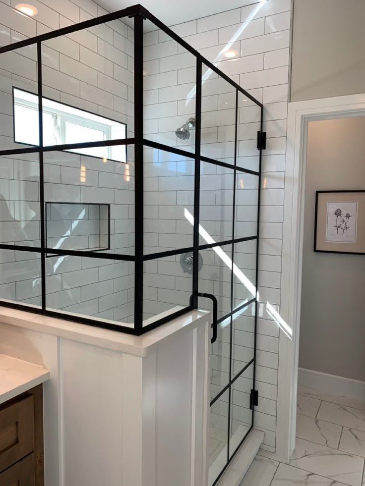 Glas Plus job: industrial style with a black grid and glass mounted on a wall or half wall, in a white subway tile shower