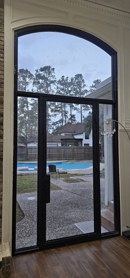 Glas Plus storefront example: glass door with an arched top and black frame, facing the patio and the pool
