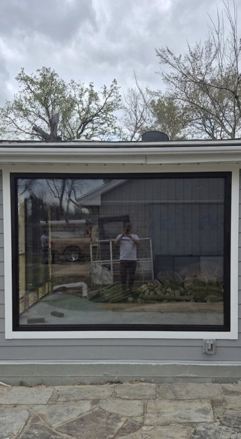 Glas Plus windows example: large glass window with a black frame installed on the front of a house