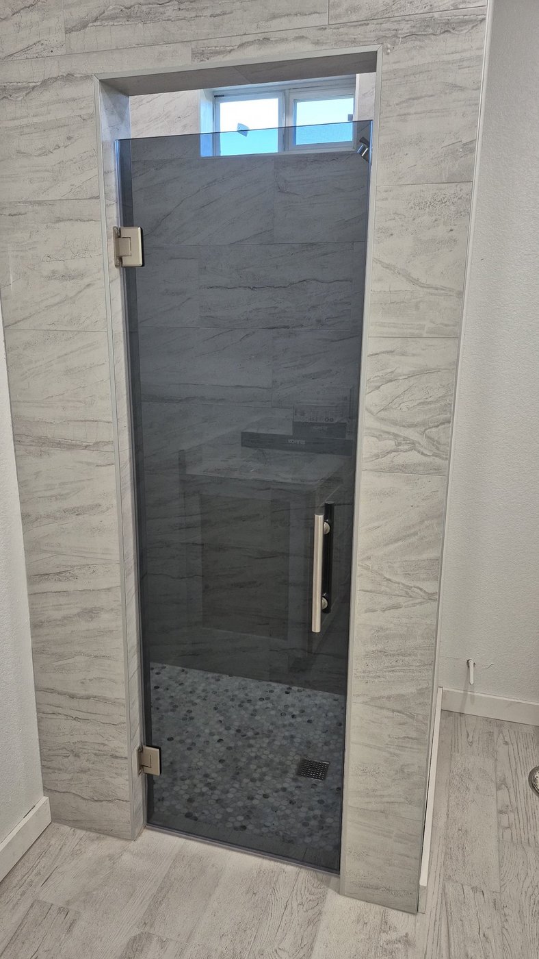 Single door with Grey glass (smoked grey) and brush nickel hardware installed by Glas Plus
