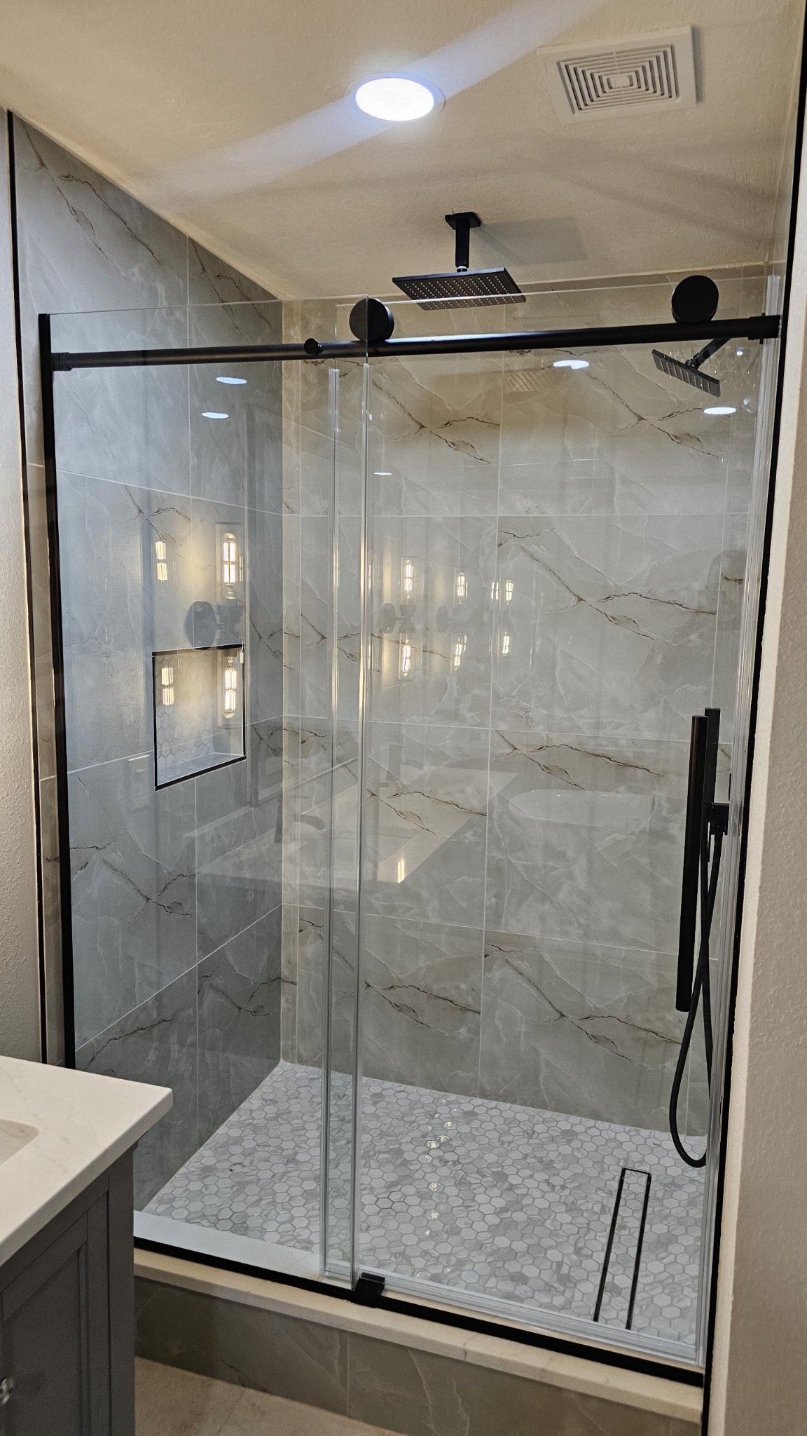 Glas Plus soft-close sliding reference photo: a soft-close sliding door and fixed clear glass panel, with black hardware