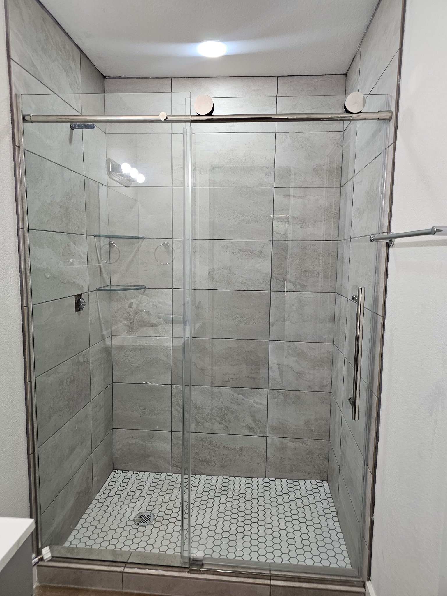 Soft-close sliding with chrome hardware and fixed panel installed by Glas Plus